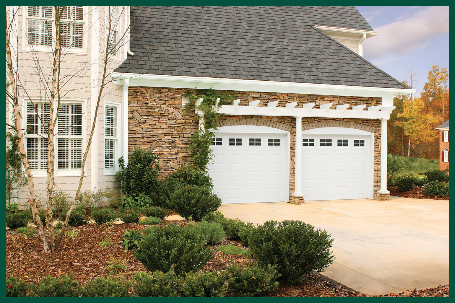 House with two white arched garage doors