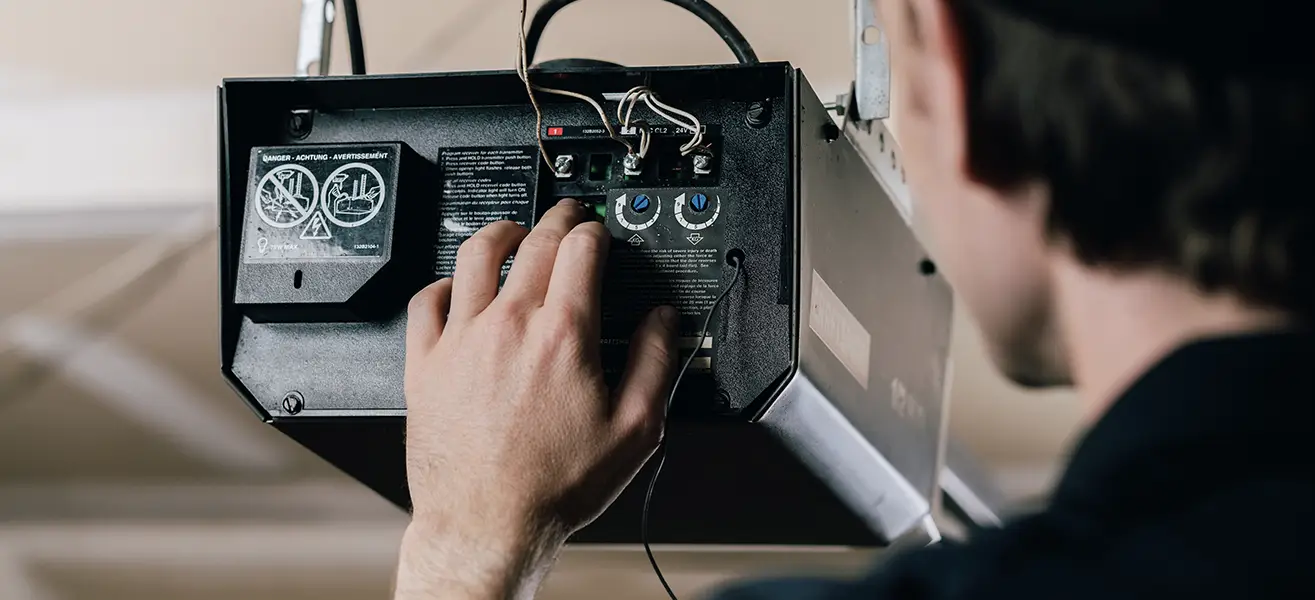 A qualified service professional installing one of the best garage door openers.