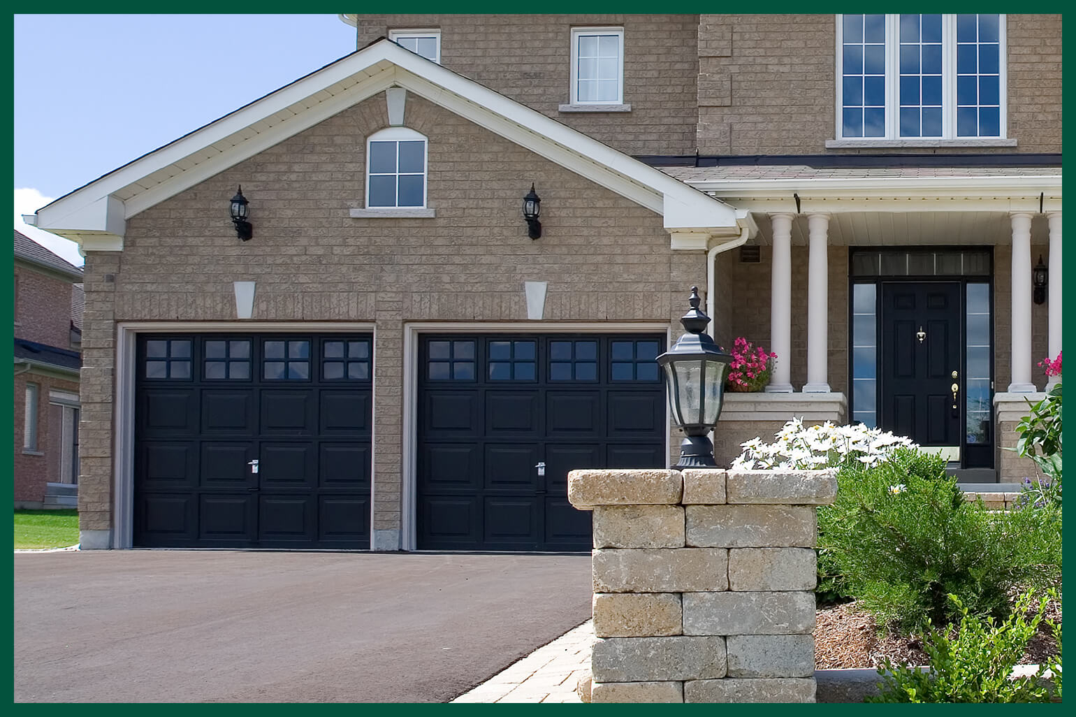 Brick house with black painted garage doors