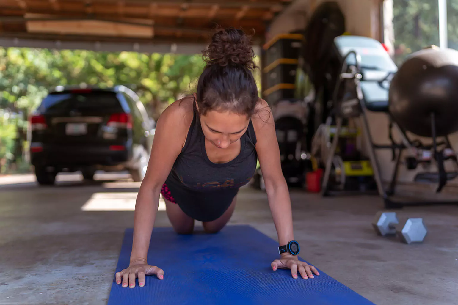 A person doing plank in a garage gym.