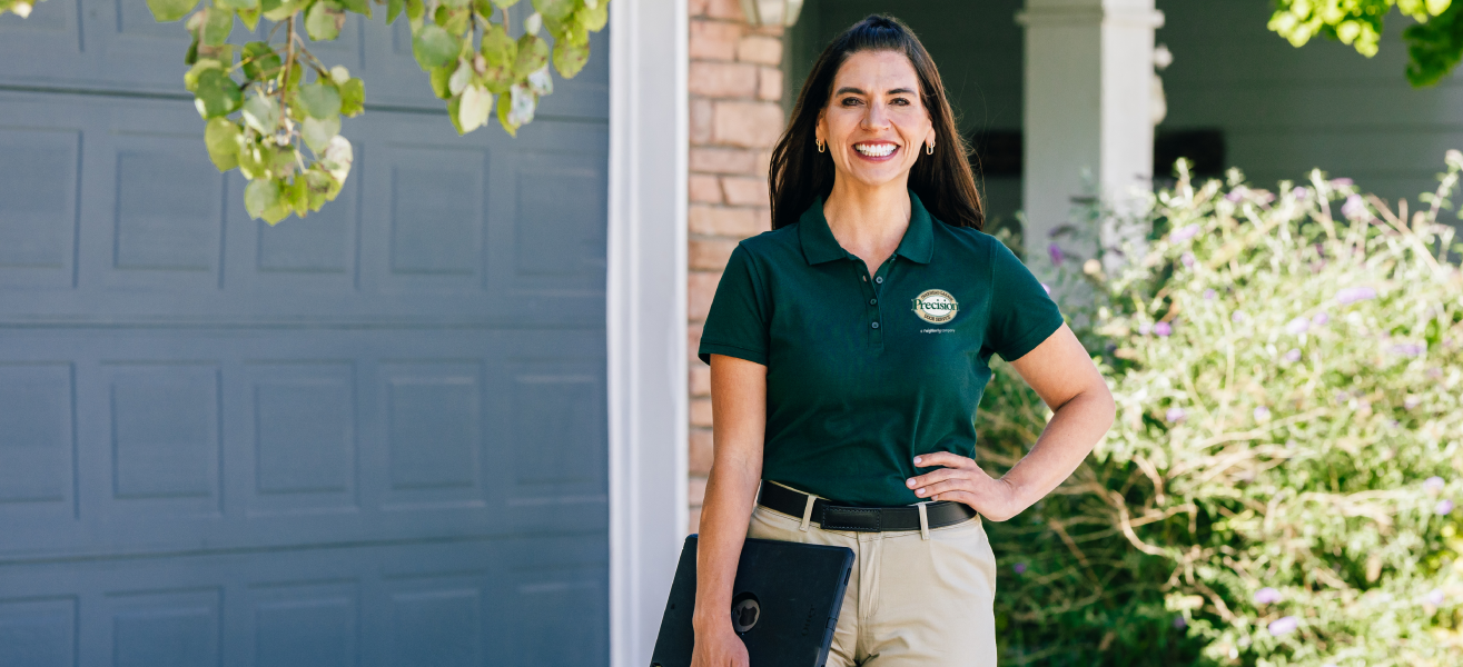 Precision Garage Door Service standing in front a fixed garage door.