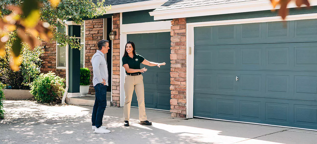 A Precision Garage Door Service professional installs a new door after a fire.