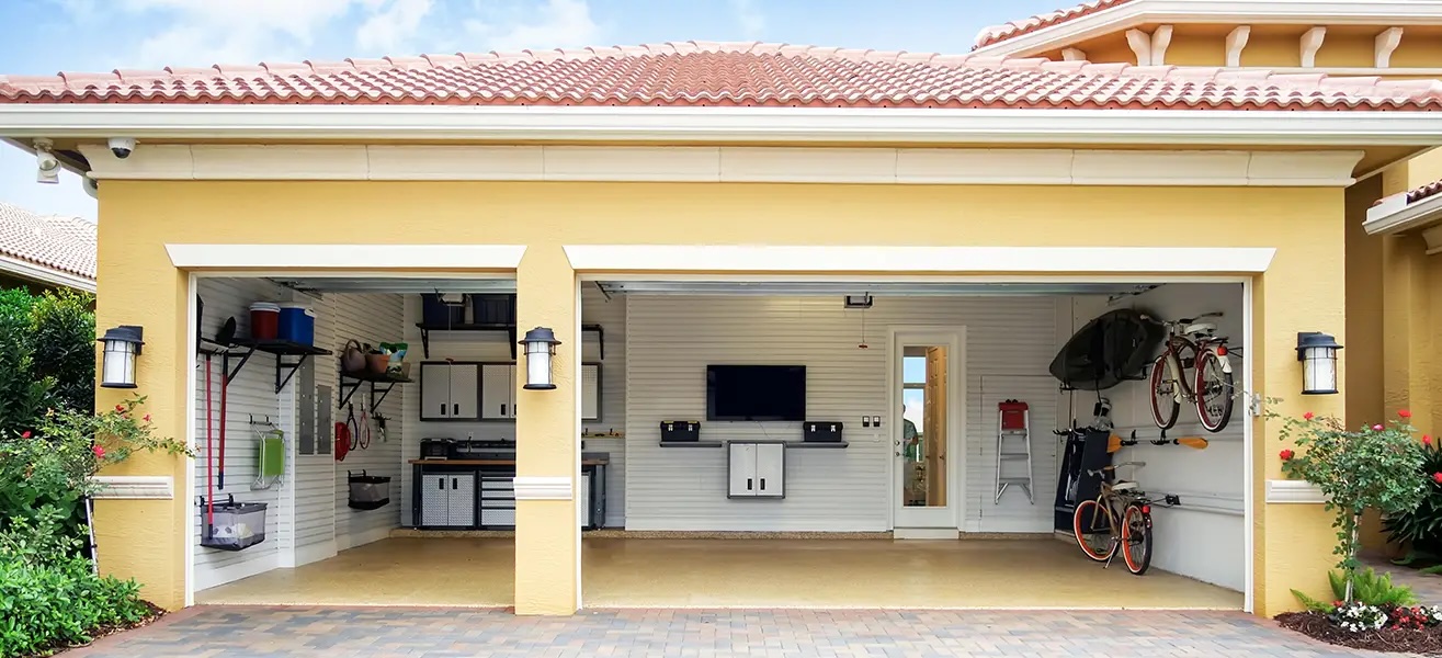 Photograph of a converted garage with a TV and hardwood floors for entertaining.