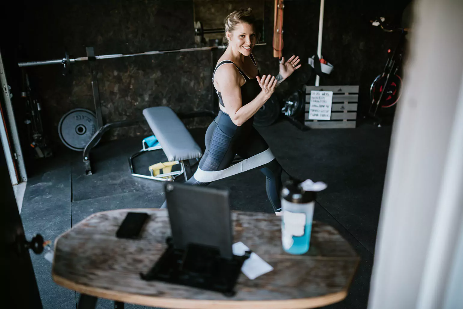 A person working out in a crowded/half garage half gym