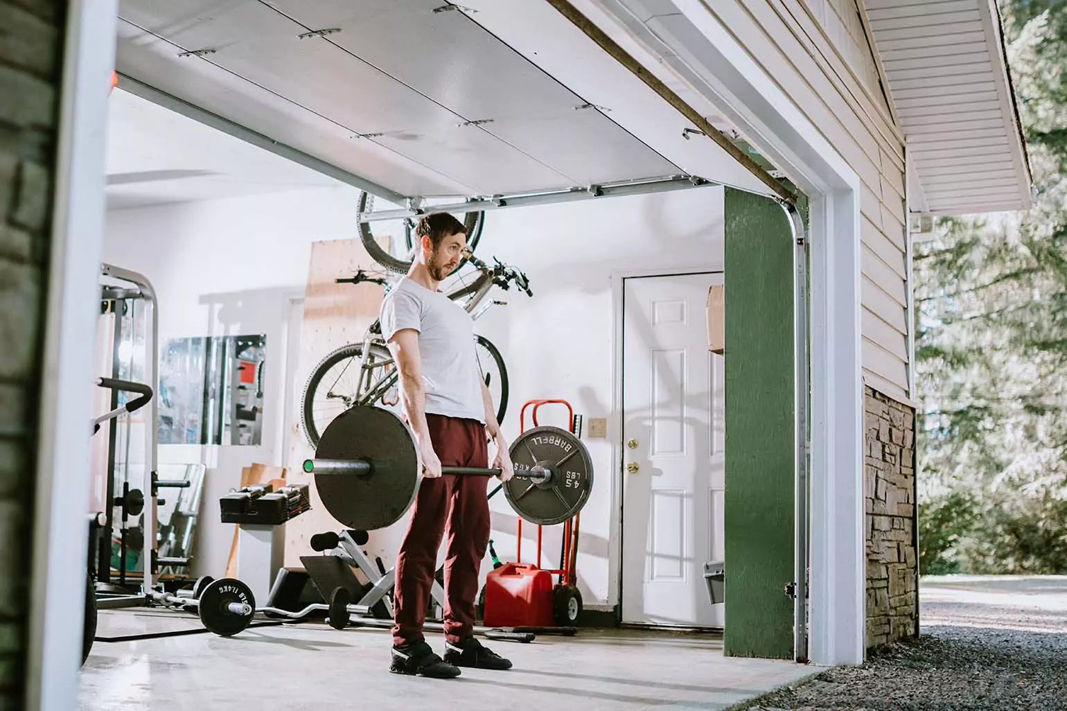 Person performing deadlifts in their garage.