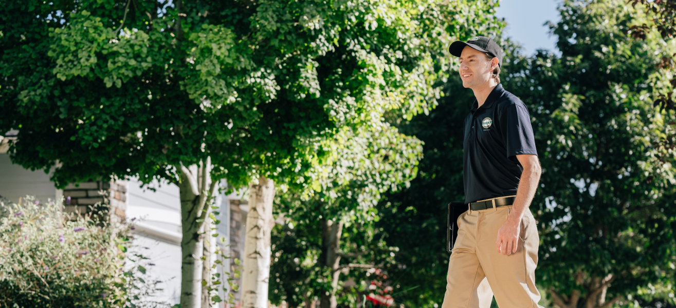 A Precision Garage Door Service professional walks up to a customer’s home.