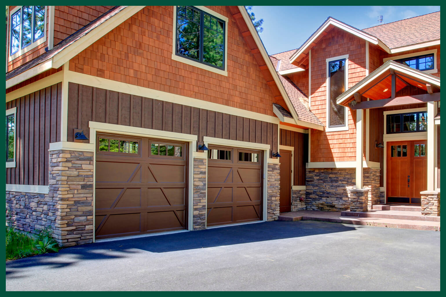 Beautiful stone house with white garage doors