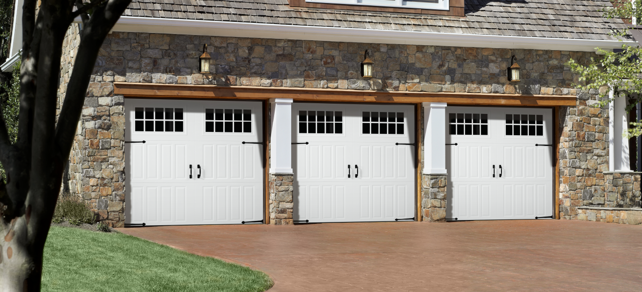 Three swing-out garage door on a brick house.