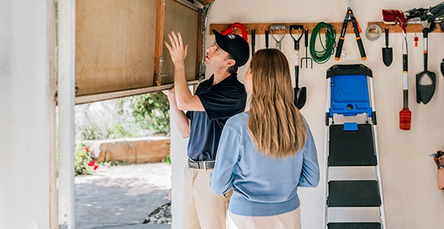 A PDS employee working on a roof with a client.