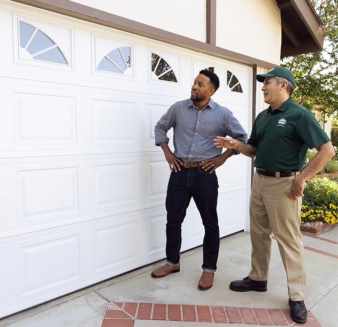 worker and customer in front of garage door