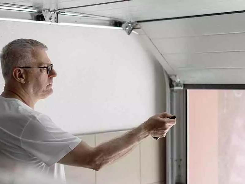 Man using a garage door opener.