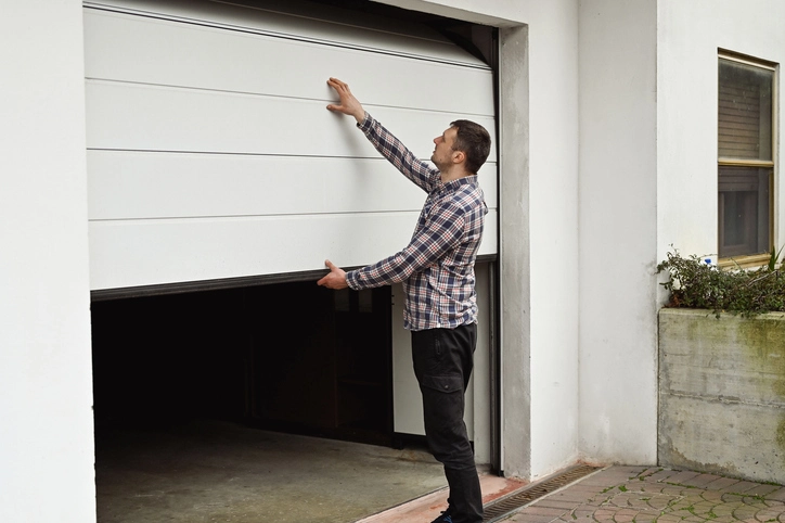 Man repairing garage door | Precision Garage Door Service of Knoxville.