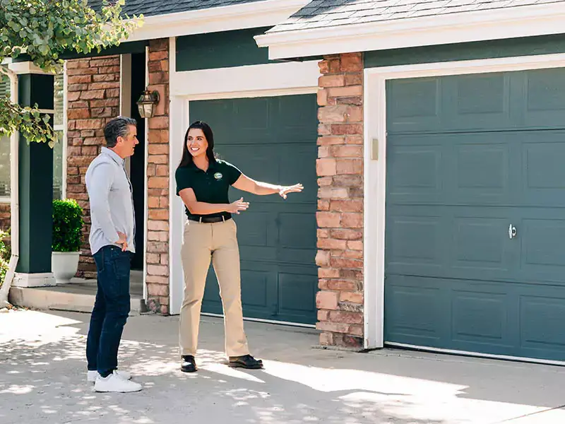 A Precision Garage Door Service professional installs a new door after a fire.