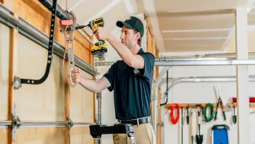 A Precision Garage Door Service professional completes a tune-up as part of a customer’s routine garage door maintenance.