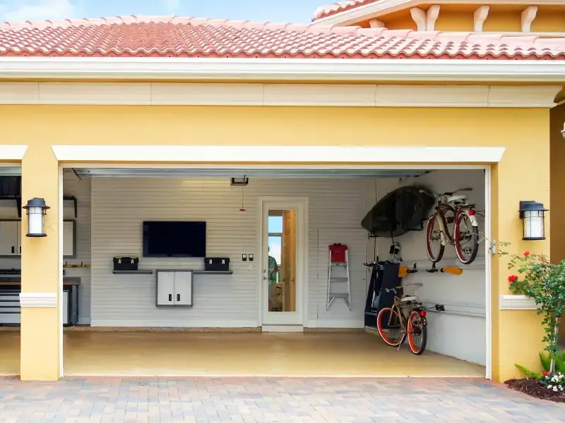 A remodeled garage with new fixtures in a yellow house.