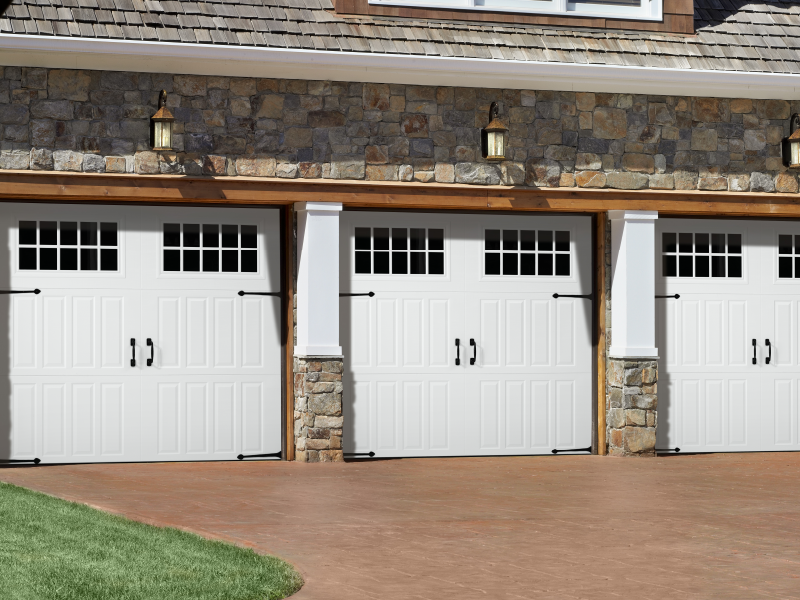 Three swing-out garage door on a brick house.